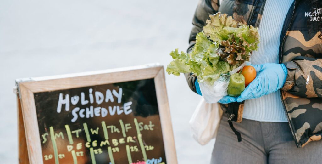 Marketing crop unrecognizable woman in gloves holding ripe vegetables on street