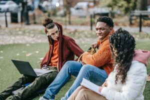 multiethnic students sitting in park