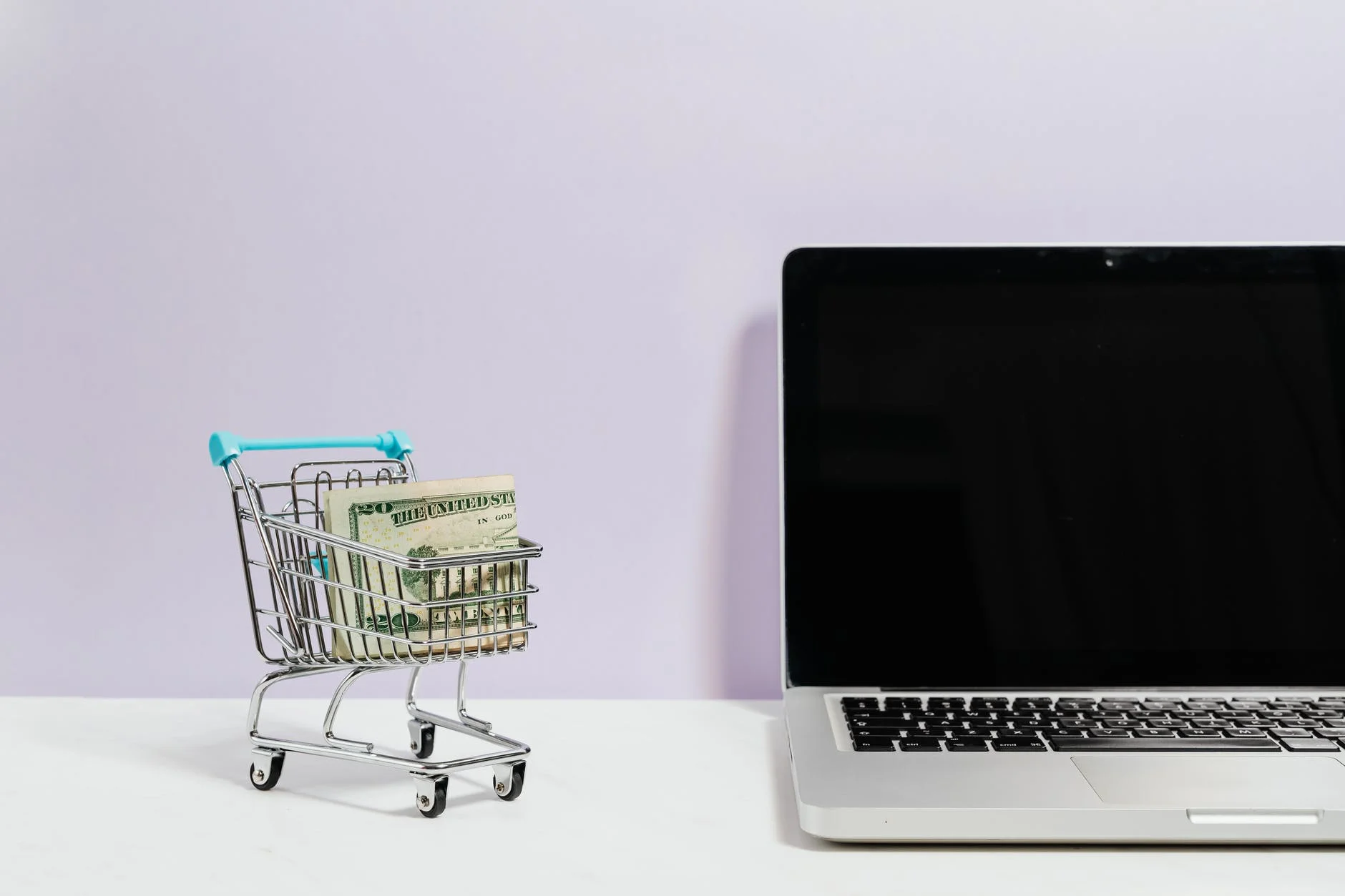 10 Awesome Cheapest Web Hosting Here To Consider | Start Entrepreneur Online macbook pro on white table beside a miniature shopping cart with money